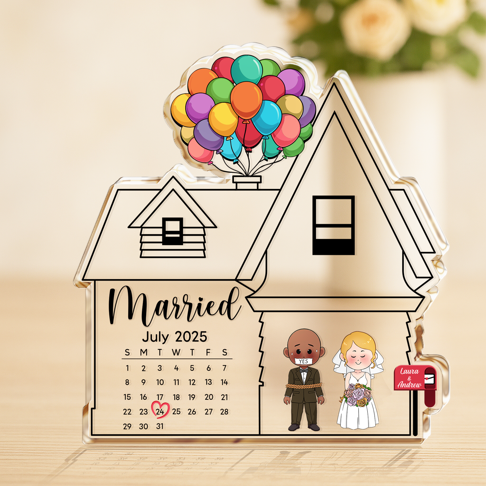 Close-up of a personalized wedding calendar on clear acrylic with a red heart